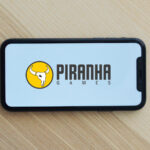 Piranha Games logo on a mobile phone