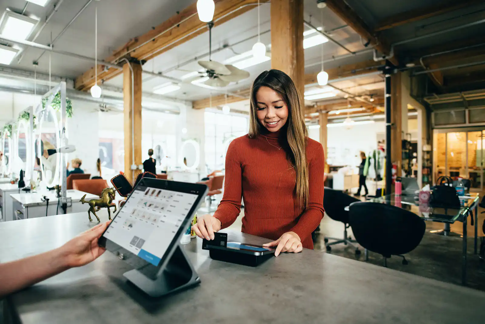 A person paying for their item at a retail shop
