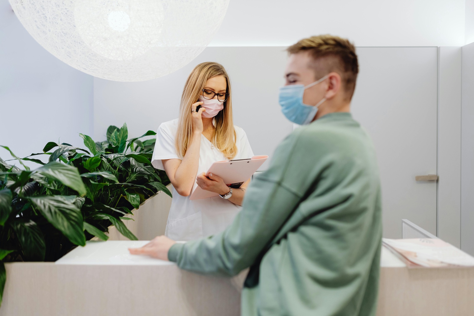 A receptionist picking up the phone to request an interpreter