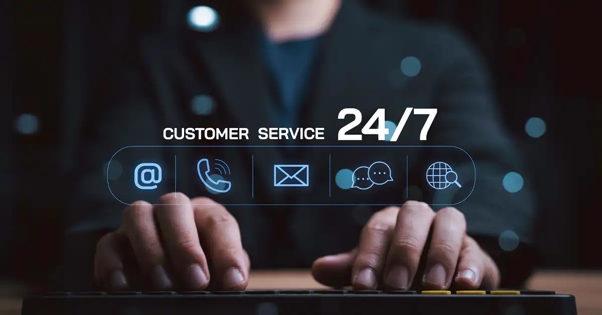 A person working at a keyboard with a digital overlay showing 24/7 customer service icons for email, phone, and global support