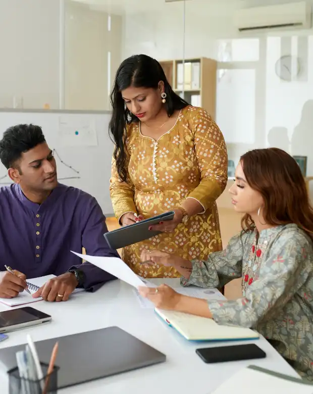 Professional partners reviewing data on a computer, symbolizing Hindi language and localization services