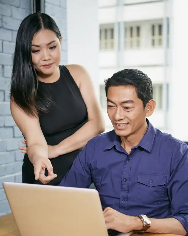 Business partners reviewing content on a tablet, symbolizing Lao linguistic and business services