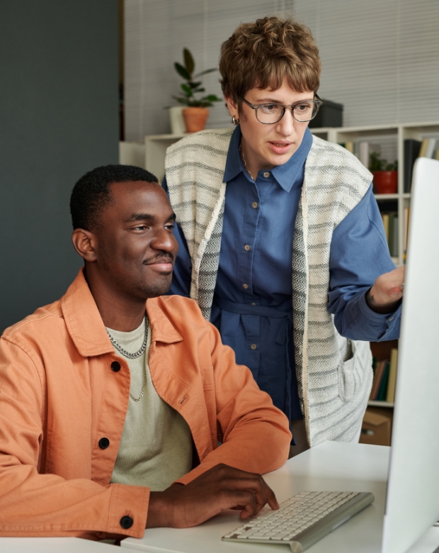 A professional duo reviewing technical reports, symbolizing Norwegian linguistic and business support