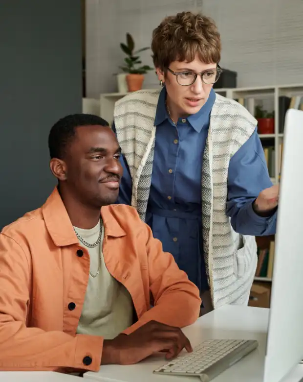 A professional duo reviewing technical reports, symbolizing Norwegian linguistic and business support